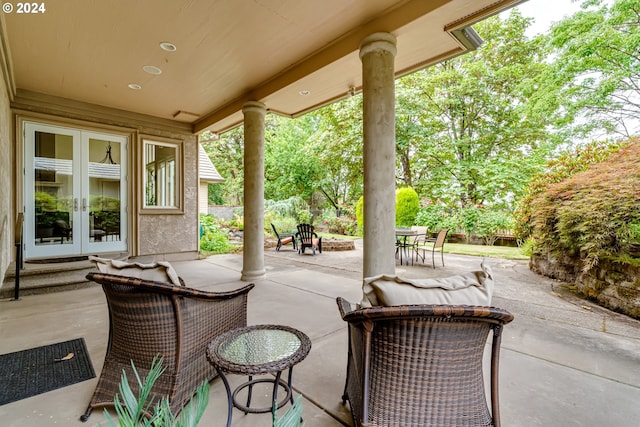 view of patio / terrace featuring outdoor dining space, fence, and french doors