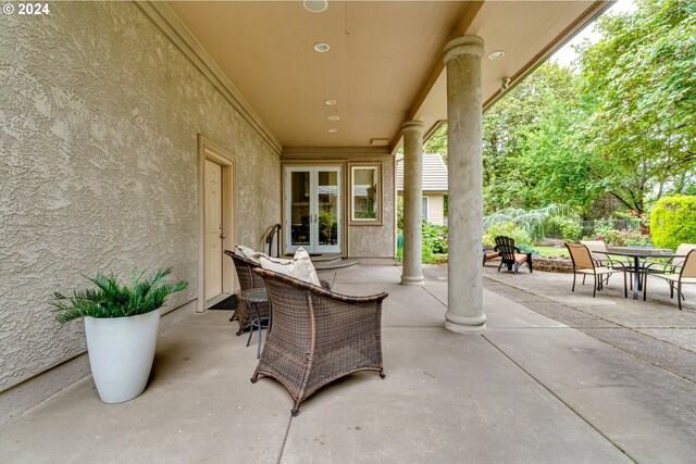 rear view of property featuring a balcony, a patio, and a yard