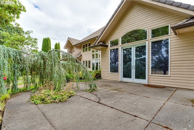 rear view of house with a balcony, an outdoor fire pit, a patio, and a yard