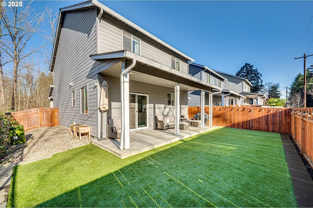 back of house with a yard and a patio