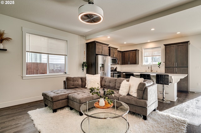 living room with dark wood-type flooring and sink