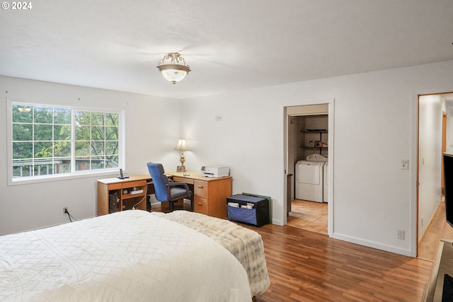 bedroom featuring independent washer and dryer and light wood-type flooring