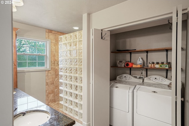 washroom featuring washer and clothes dryer and sink