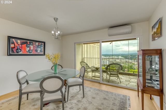 dining space featuring hardwood / wood-style floors, an inviting chandelier, and a wall unit AC