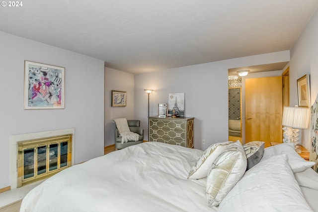 bedroom featuring a fireplace and ensuite bath