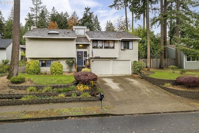 split foyer home featuring a front yard and a garage