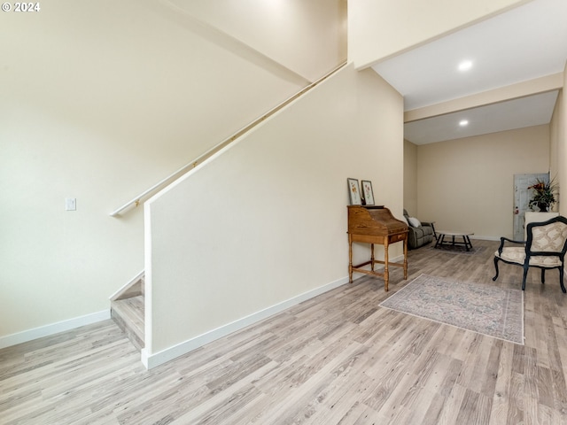 sitting room featuring stairway, recessed lighting, wood finished floors, and baseboards