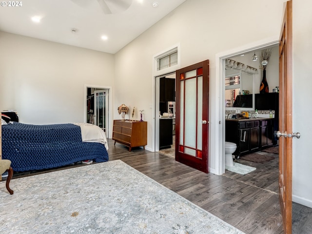 bedroom with a spacious closet, ceiling fan, a closet, dark hardwood / wood-style floors, and ensuite bath