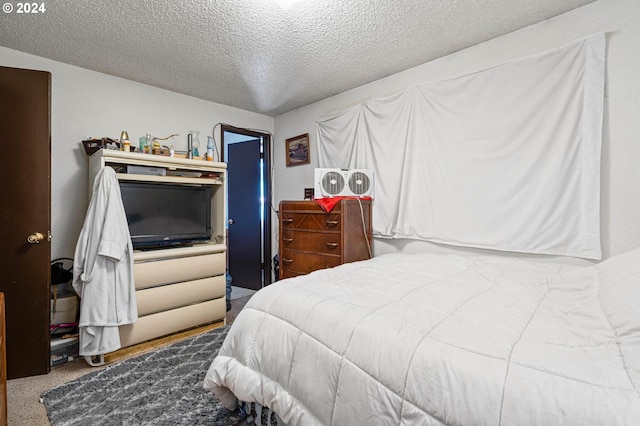 bedroom featuring a textured ceiling and carpet floors