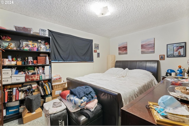 bedroom featuring a textured ceiling and carpet floors