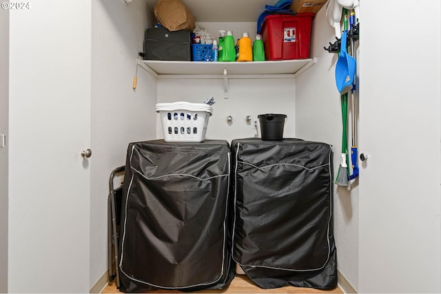 washroom with hardwood / wood-style flooring and independent washer and dryer