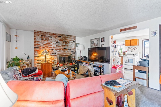 carpeted living room with a brick fireplace and a textured ceiling