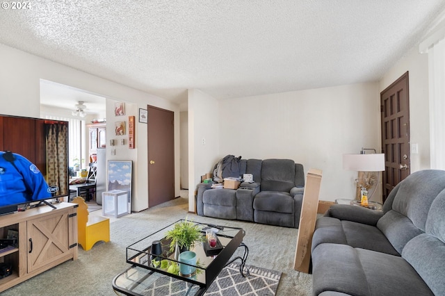 carpeted living room featuring a textured ceiling and ceiling fan