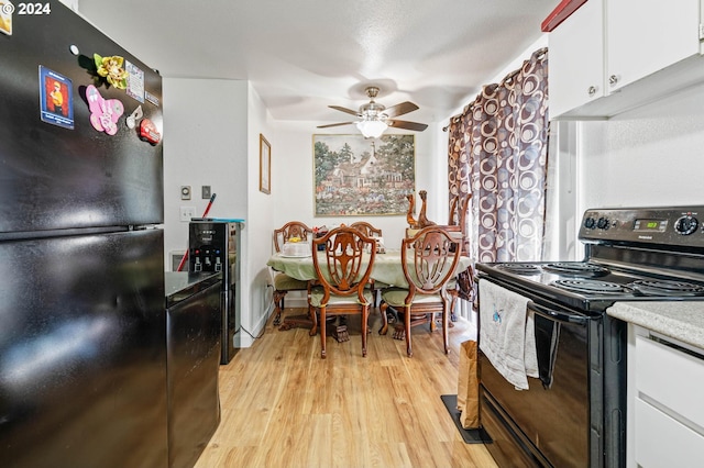 kitchen featuring ceiling fan, white cabinets, light hardwood / wood-style floors, and black appliances