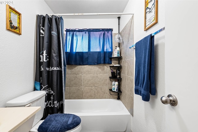 bathroom featuring shower / tub combo with curtain and toilet