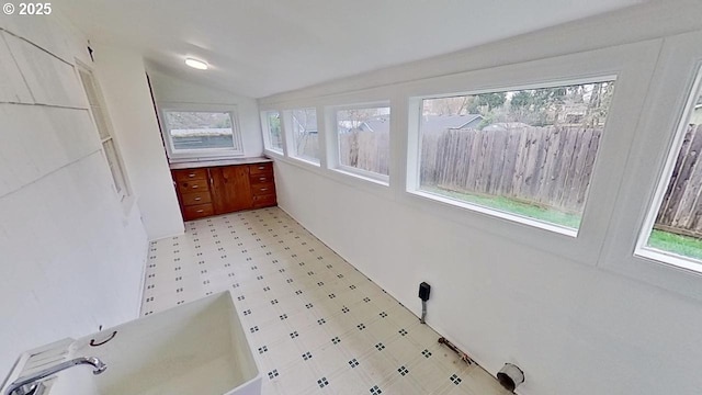 bathroom featuring tile patterned floors and vaulted ceiling