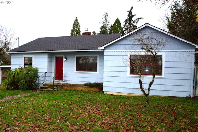 single story home with a front lawn, a chimney, and a shingled roof