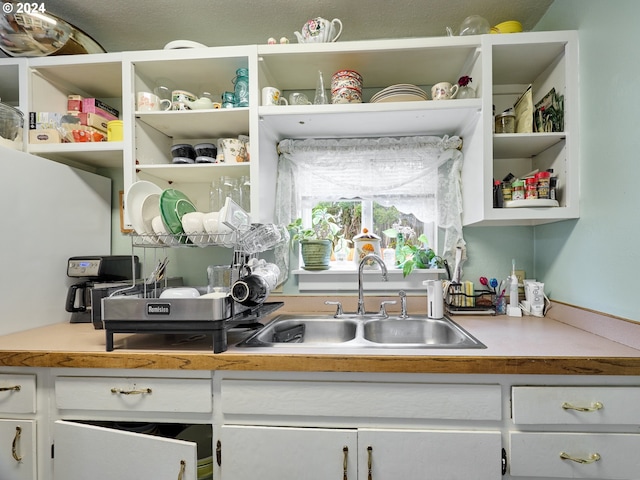 interior space with sink and white cabinetry