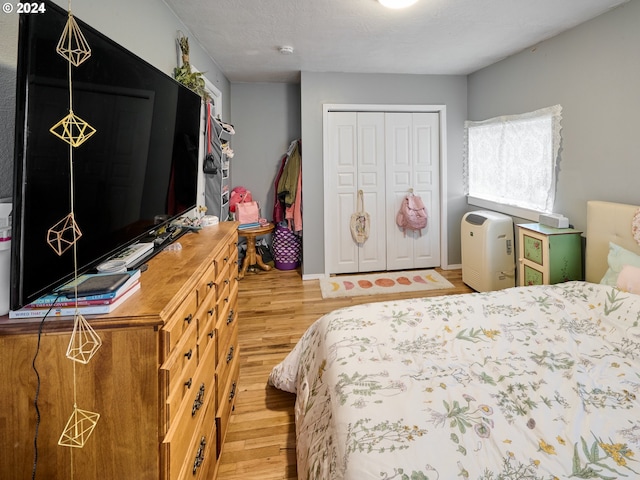 bedroom with a closet and hardwood / wood-style floors