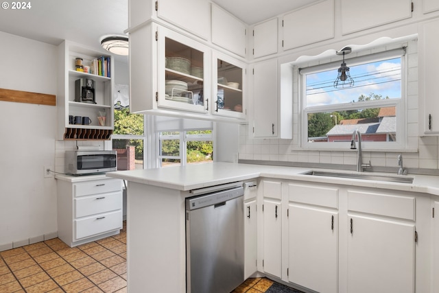 2405 Maple St, Longview, WA 98632 - kitchen with a sink, backsplash, white cabinets, and stainless steel appliances