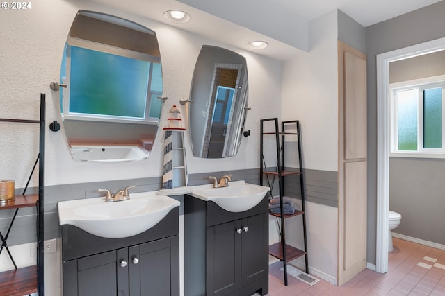 bathroom featuring vanity, toilet, and tile patterned flooring