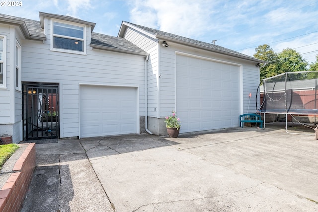 2405 Maple St, Longview, WA 98632 - garage featuring a trampoline and concrete driveway
