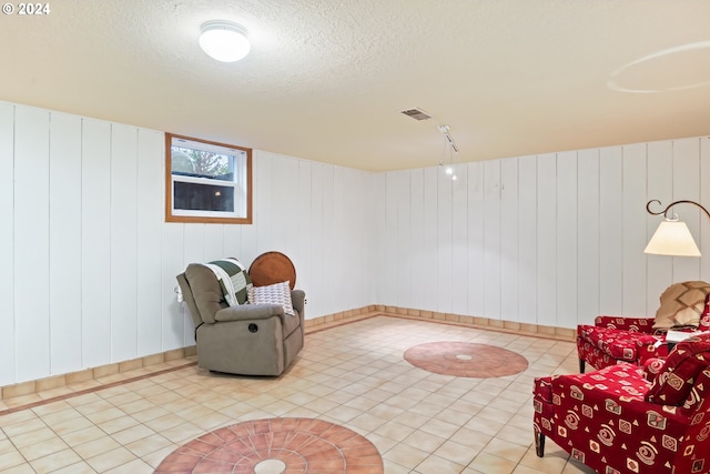 sitting room featuring wood walls