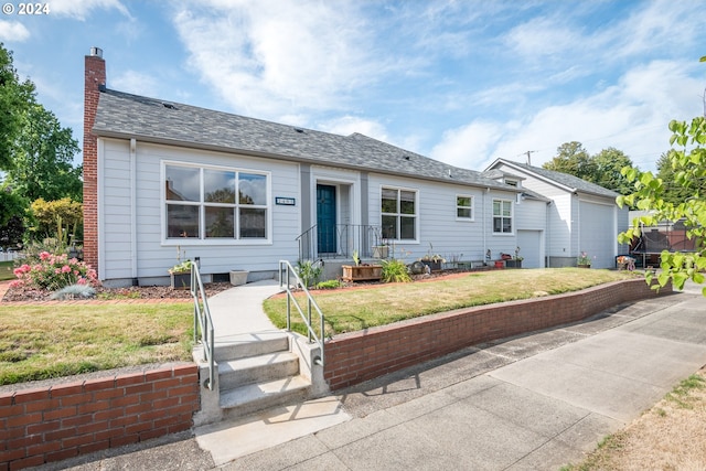 ranch-style house with a front yard and a garage