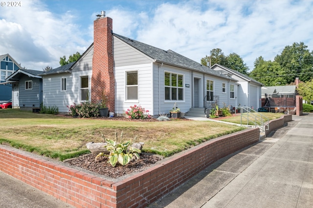 2405 Maple St, Longview, WA 98632 - view of front of home featuring an attached garage, a front lawn, and a chimney