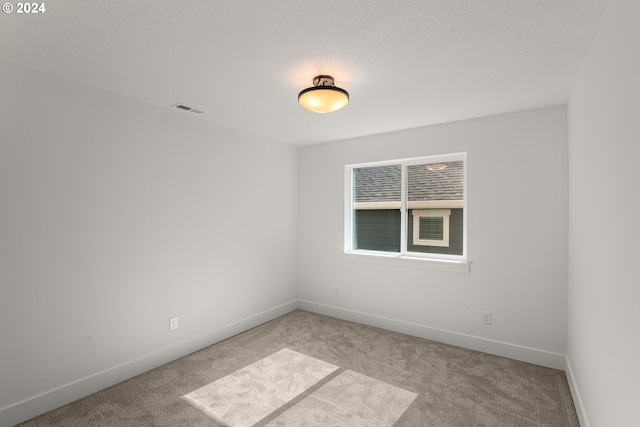 unfurnished room featuring light colored carpet