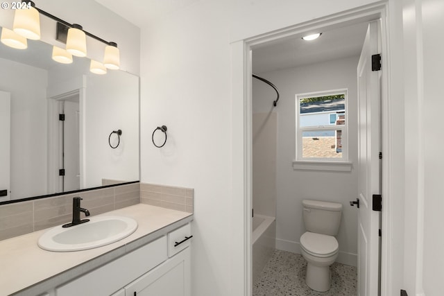 full bathroom with decorative backsplash, toilet, vanity, and bathing tub / shower combination