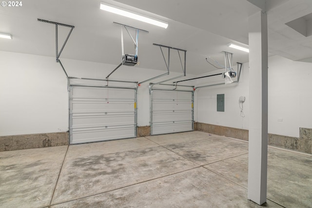 garage featuring electric panel and a garage door opener