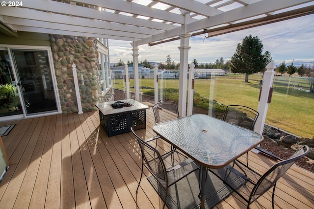 deck featuring a pergola and a lawn