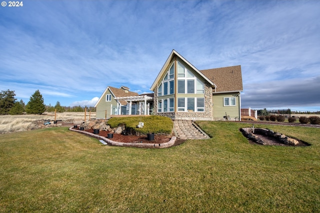 rear view of property with a lawn