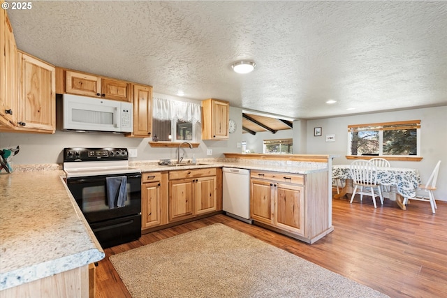 17943 Old Auburn Ln, Baker City, OR 97814 - kitchen featuring white appliances, a sink, a peninsula, a textured ceiling, and light countertops