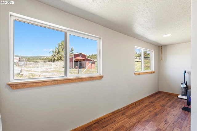 17943 Old Auburn Ln, Baker City, OR 97814 - workout area with wood finished floors, a textured ceiling, and baseboards