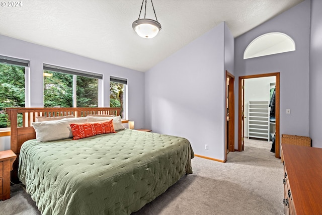 bedroom featuring baseboards, light colored carpet, a textured ceiling, and lofted ceiling