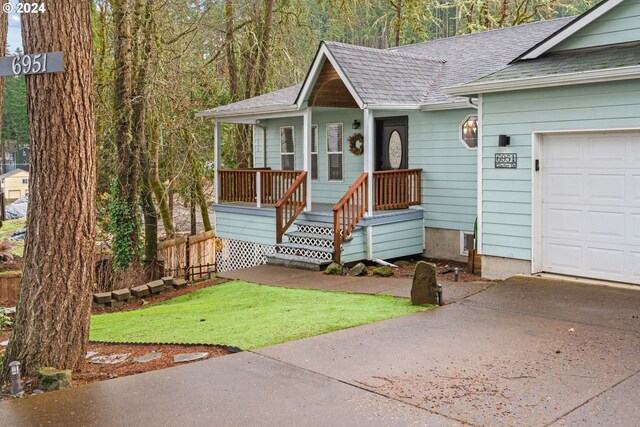 view of front of home with a garage and a front yard