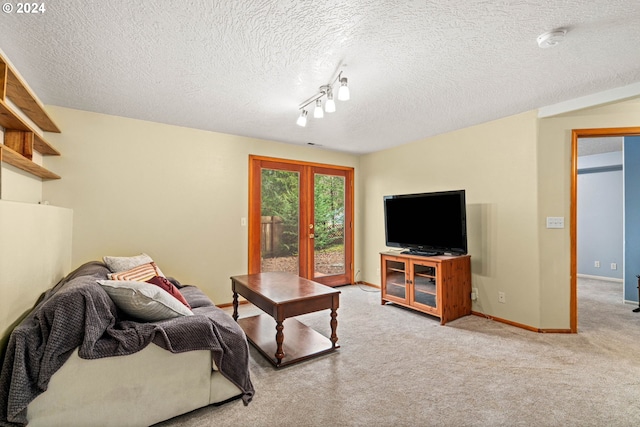 carpeted living room featuring french doors, baseboards, and a textured ceiling