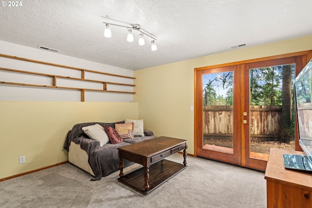 interior space featuring visible vents, carpet flooring, and french doors