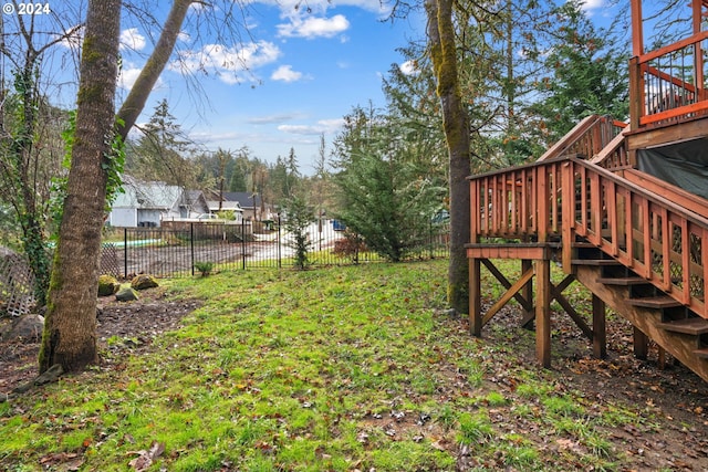 view of yard featuring stairway and fence