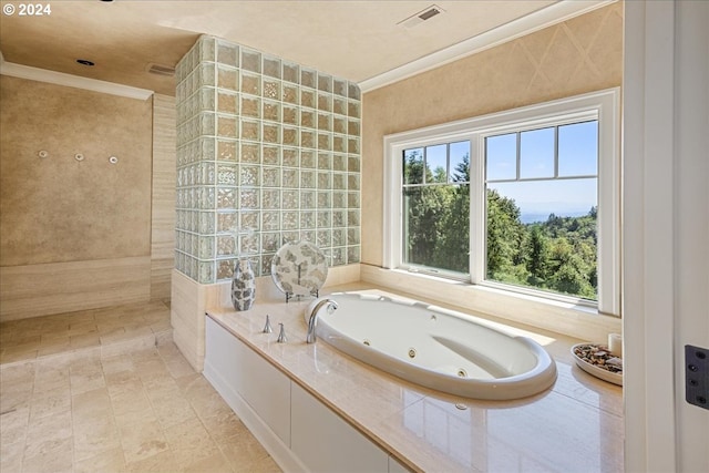 bathroom with tiled tub, tile patterned flooring, and ornamental molding