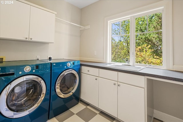 washroom with sink, separate washer and dryer, and cabinets