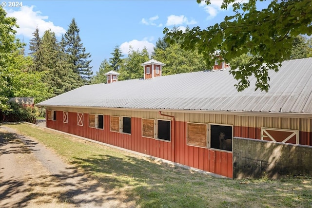 view of side of property featuring an outbuilding