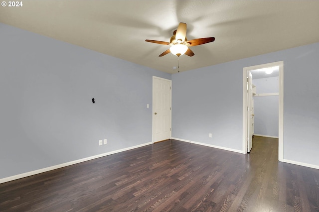 unfurnished room featuring dark wood-type flooring and ceiling fan