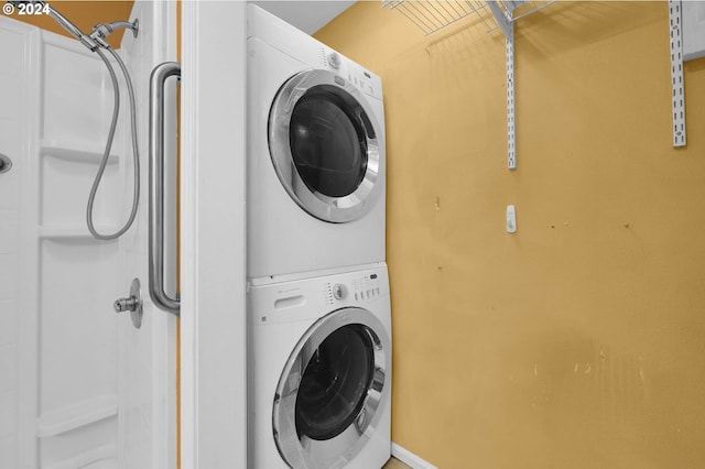 laundry room featuring stacked washer and clothes dryer