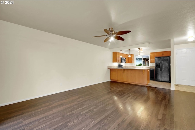 unfurnished living room with hardwood / wood-style floors and ceiling fan