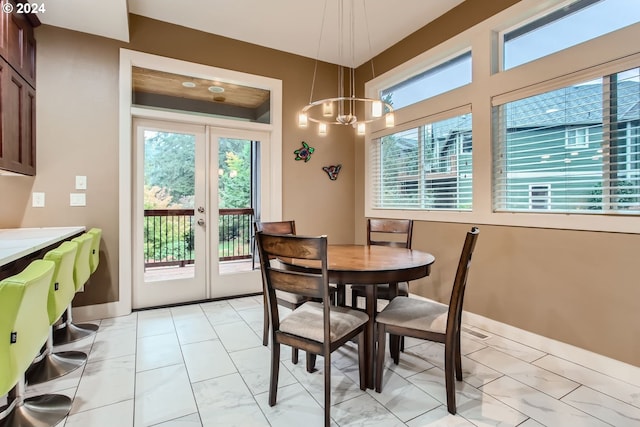 13829 SE Claremont St, Happy Valley, OR 97086 - dining area with light marble finish floors, a chandelier, baseboards, and french doors