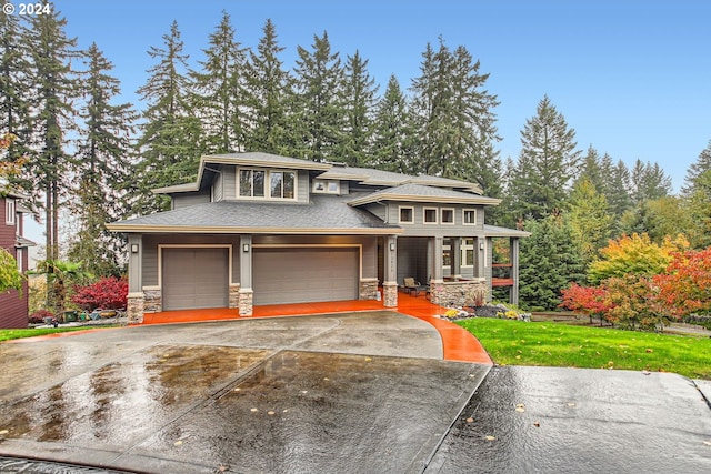 13829 SE Claremont St, Happy Valley, OR 97086 - prairie-style house with stone siding, covered porch, a garage, driveway, and roof with shingles