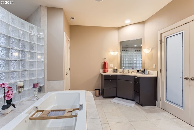 bathroom with tile patterned floors, separate shower and tub, and vanity